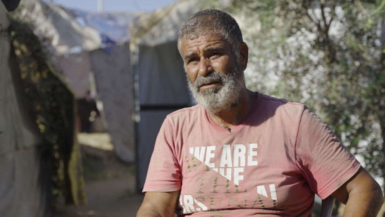 Rafik Hamdi Darwish Yasin speaks with The Real News from his shelter in the Gaza Strip. Screenshot from video by XXX