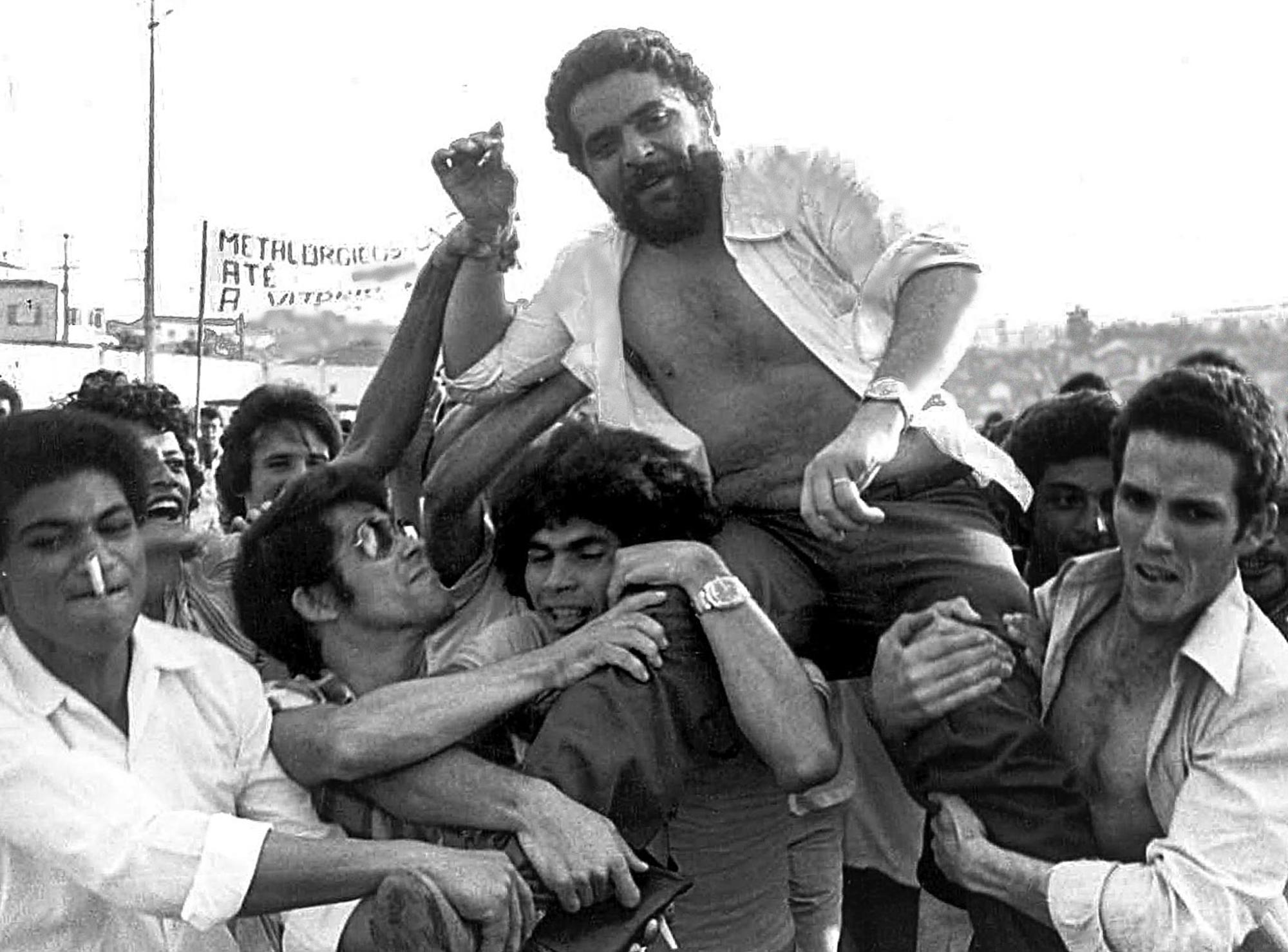 This 22 March 1979 file photo shows Luiz Inacio Lula da Silva being lifted by metalworker colleagues after a union rally in Brazil