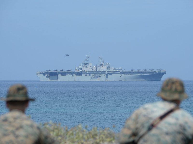 US Marines watch the US navy multipurpose amphibious assault ship 'USS Wasp' with F-35 lightning fighter jets on the deck during the amphibious landing exercises as part of the annual joint US-Philippines military exercise, on the shores of San Antonio town, facing the South China sea, Zambales province on April 11, 2019. Photo by TED ALJIBE/AFP via Getty Images