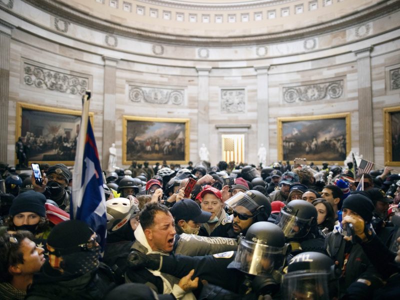 Police clash with supporters of US President Donald Trump who breached security and entered the Capitol building in Washington D.C., United States on January 06, 2021. Photo by Mostafa Bassim/Anadolu Agency via Getty Images