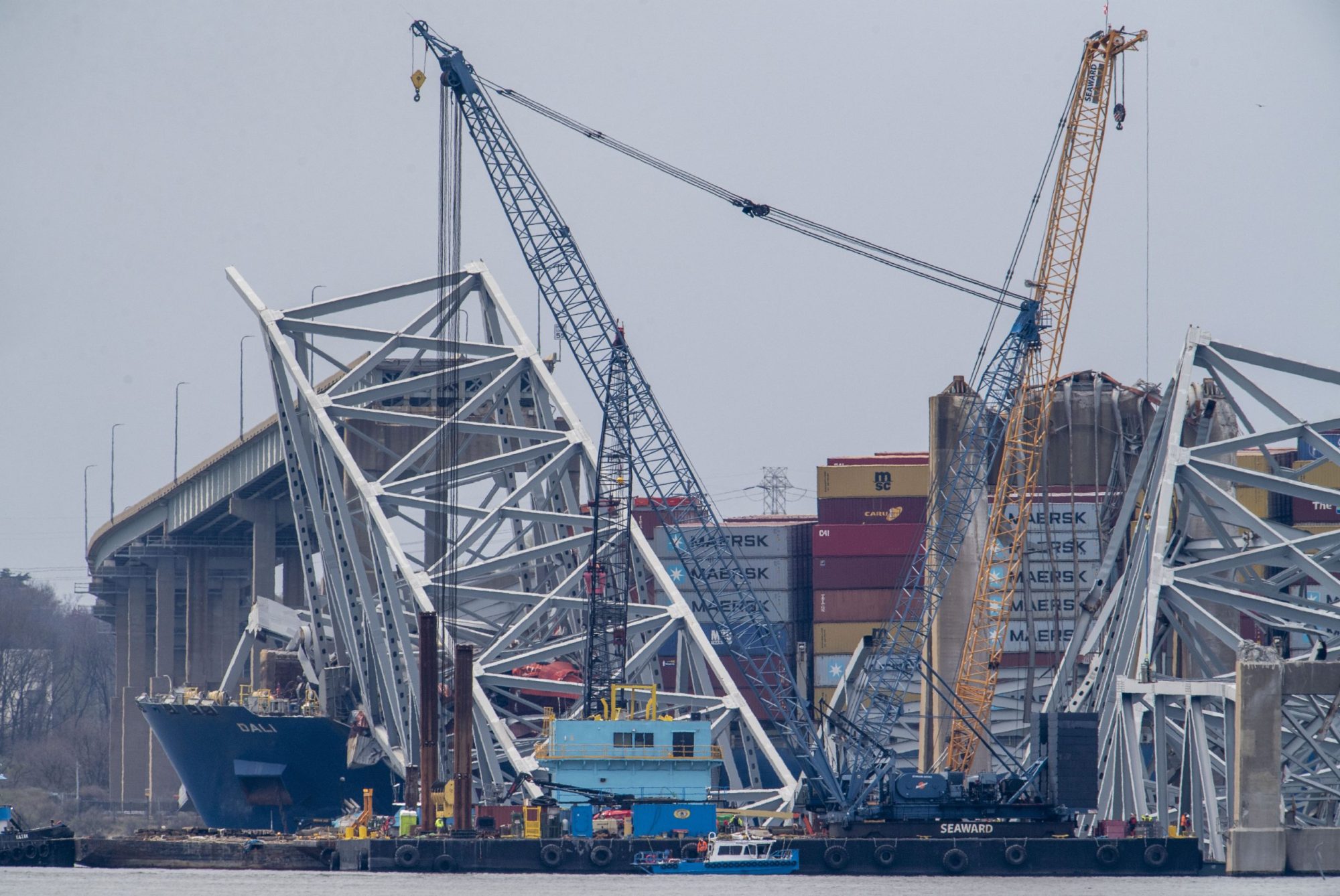 Workers start to clear the channel of the twisted metal and concrete of the Francis Scott Key Bridge, as authorities turn their focus to "salvage" operations with heavy duty cranes to remove wreckage from the Patapsco River after the massive container ship, Dali, caused Baltimore's Key Bridge to collapse on March 30, 2024. Photo by Jonathan Newton/for The Washington Post via Getty Images