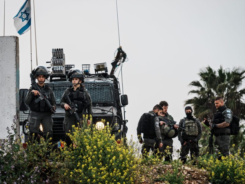 Israeli soldiers stand armed and ready as they watch over West Bank Palestinian residents with conditional permits, cross into a checkpoint to enter Jerusalem to pray at the Al-Aqsa in the Old City for Ramadan, in Qalandia, Occupied West Bank , Friday, March 29, 2024. MARCUS YAM / LOS ANGELES TIMES