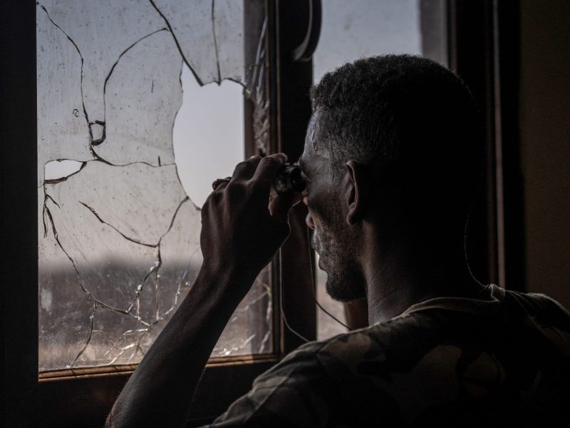 Sudanese army soldier scans the frontline with binoculars in Khartoum North on November 3, 2024. Photo by AMAURY FALT-BROWN/AFP via Getty Images