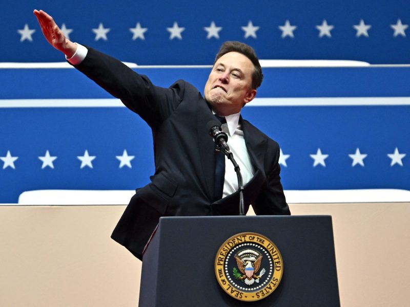 TOPSHOT - Tesla and SpaceX CEO Elon Musk gestures as he speaks during the inaugural parade inside Capitol One Arena, in Washington, DC, on January 20, 2025. Photo by ANGELA WEISS/AFP via Getty Images