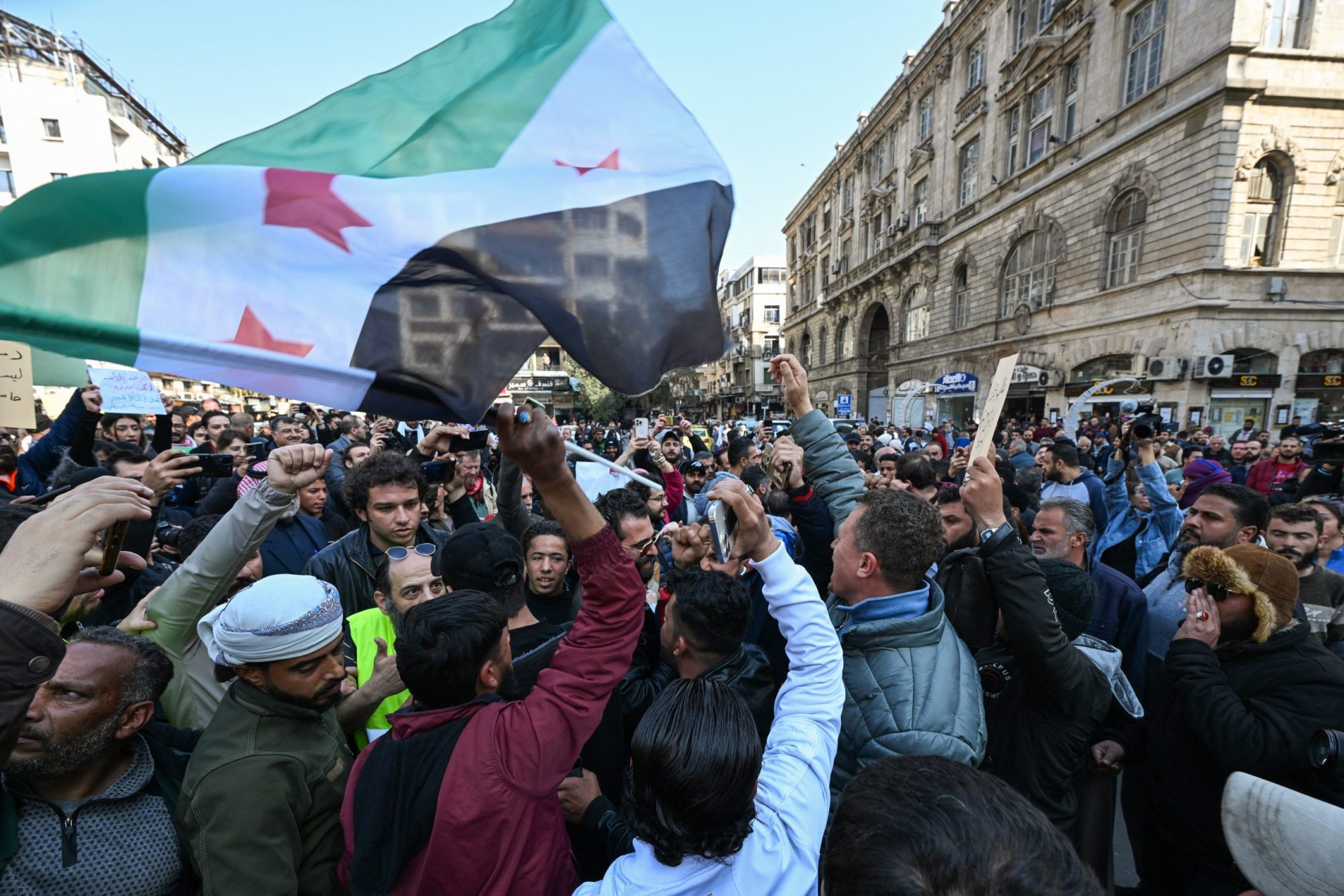 People chant slogans during a rally called for by Syrian activists and civil society representatives "to mourn for the civilian and security personnel casualties", at al-Marjeh square in Damascus on March 9, 2025. Photo by -/AFP via Getty Images