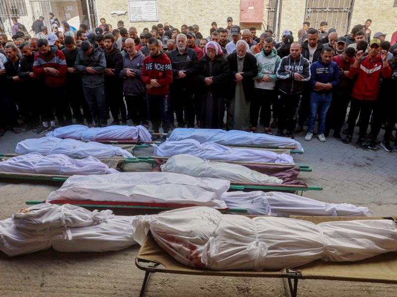 Palestinian mourners pray over the bodies of victims of overnight Israeli airstrikes on the Gaza Strip at Al-Ahli Arab hospital, also known as the Baptist hospital, in Gaza City ahead of their burial on March 18, 2025. Photo by OMAR AL-QATTAA/AFP via Getty Images