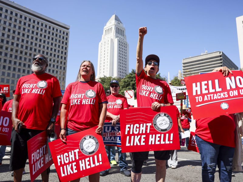 Los Angeles, CA - March 23: Postal workers Darrell Jefferies, Molly Berge, Shannon Canzoneri, and Maria Guerra rally at the Federal Building to protest the possible privatization of the USPS under the Trump administration on Sunday, March 23, 2025 in Los Angeles, CA. Juliana Yamada / Los Angeles Times via Getty Images