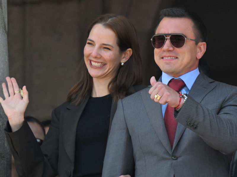 Ecuador's reelected President Daniel Noboa (R) thumbs up next to his wife, Lavinia Valbonesi, gesture from a balcony of the Carondelet Presidential Palace during the changing of the guard ceremony in Quito on April 15, 2025. Photo by RODRIGO BUENDIA/AFP via Getty Images