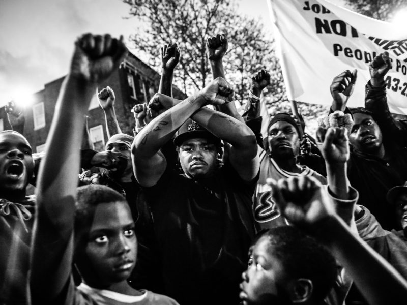 Protesters participate in a vigil for Freddie Gray down the street from the Baltimore Police Department's Western District police station, April 21, 2015, in Baltimore, Maryland. Photo by Drew Angerer/Getty Images.