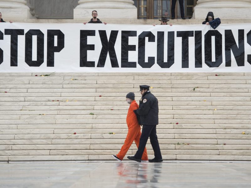 Randy Gardner is removed by police while wearing his executed brother's prison jumpsuit during an anti death penalty protest