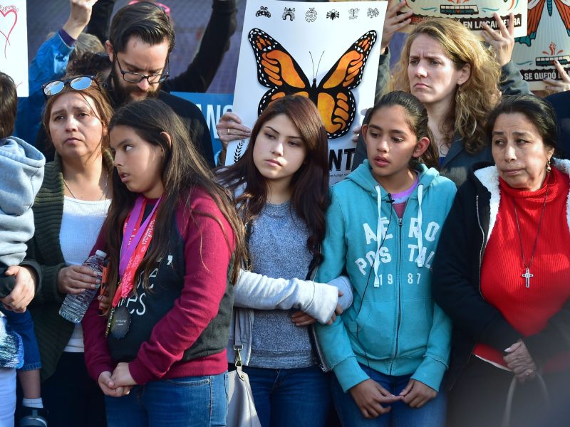 Yuleni (2nd-L), Jocelyn (C) and Fatima (2nd-R), US born daughters of undocumented Romulo Avelia-Gonzalez, who was arrested by ICE agents last week, and supporters attend a rally in downtown Los Angeles, California on March 6, 2017. Photo credit should read FREDERIC J. BROWN/AFP via Getty Images