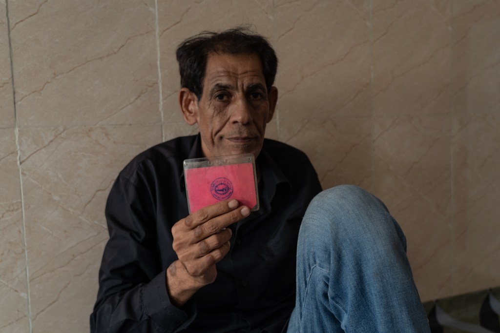 The other side of Majli's prison identity card, showing an official Abu Ghraib entry stamp.